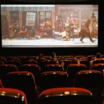 Sala de cine con butacas y pantalla de proyección